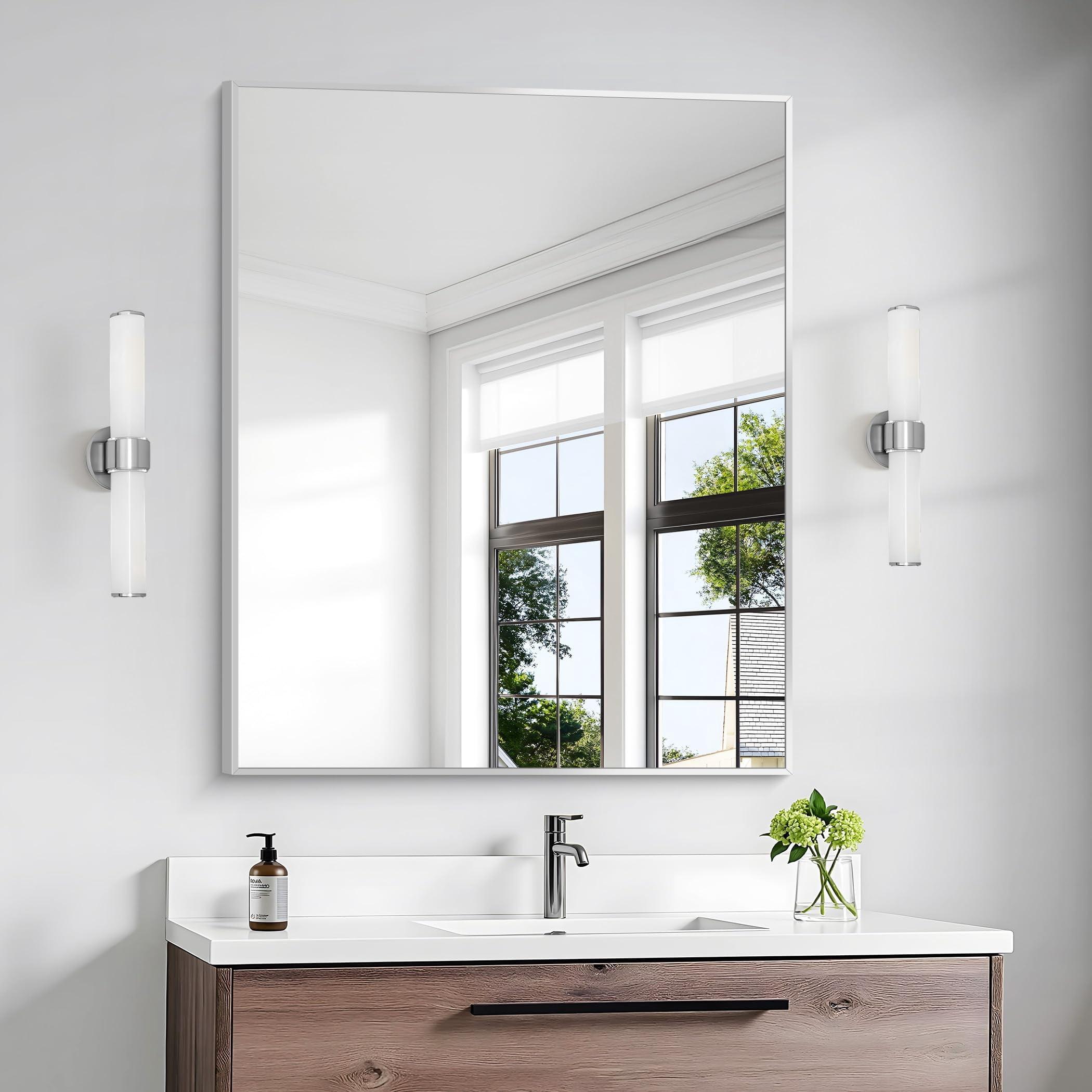 Silver square-corner bathroom mirror above a vanity